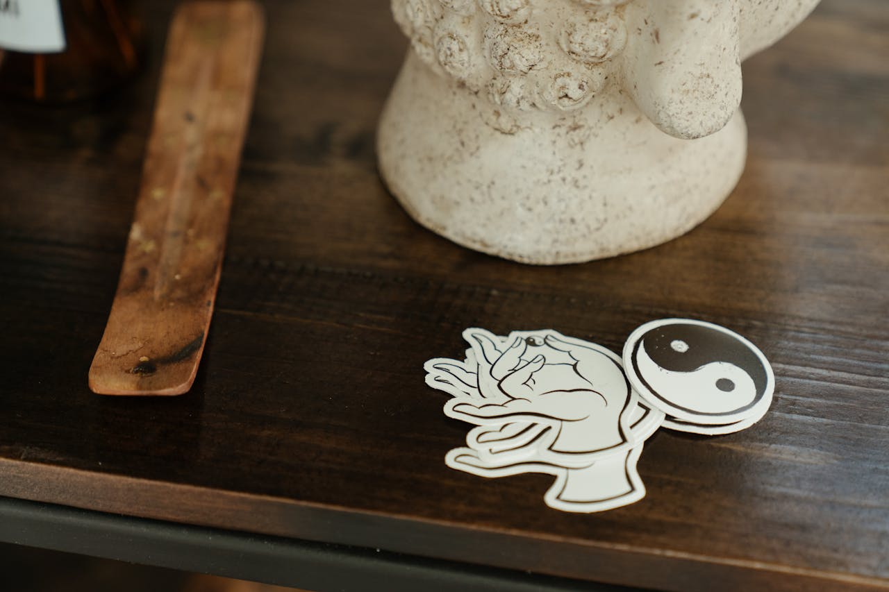 about-01 Close-up of symbolic stickers and decor on a wooden table in a peaceful indoor setting.